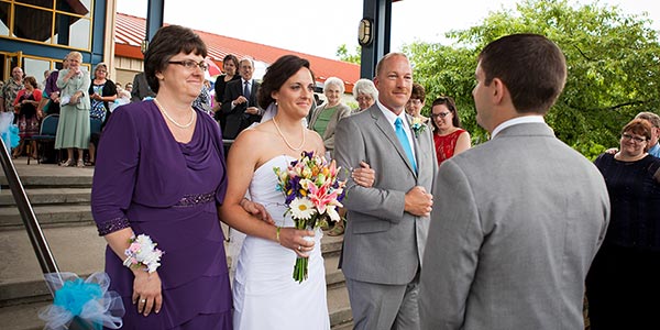 Kristi and Kerry Garman walk Katie down the aisle