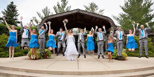 Wedding party jumping in the garden