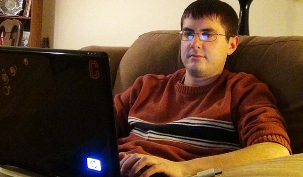 Jason Kammerdiener writing on a laptop on his lap