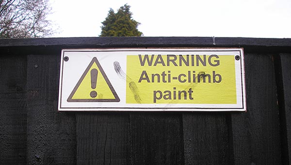Sign reading "Warning: Anti-climb paint"
